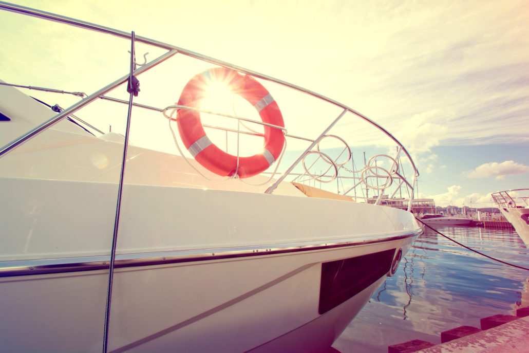 A boat docked at a marina with a life preserver, promoting safety on the water with Dockshare during National Safe Boating Week.