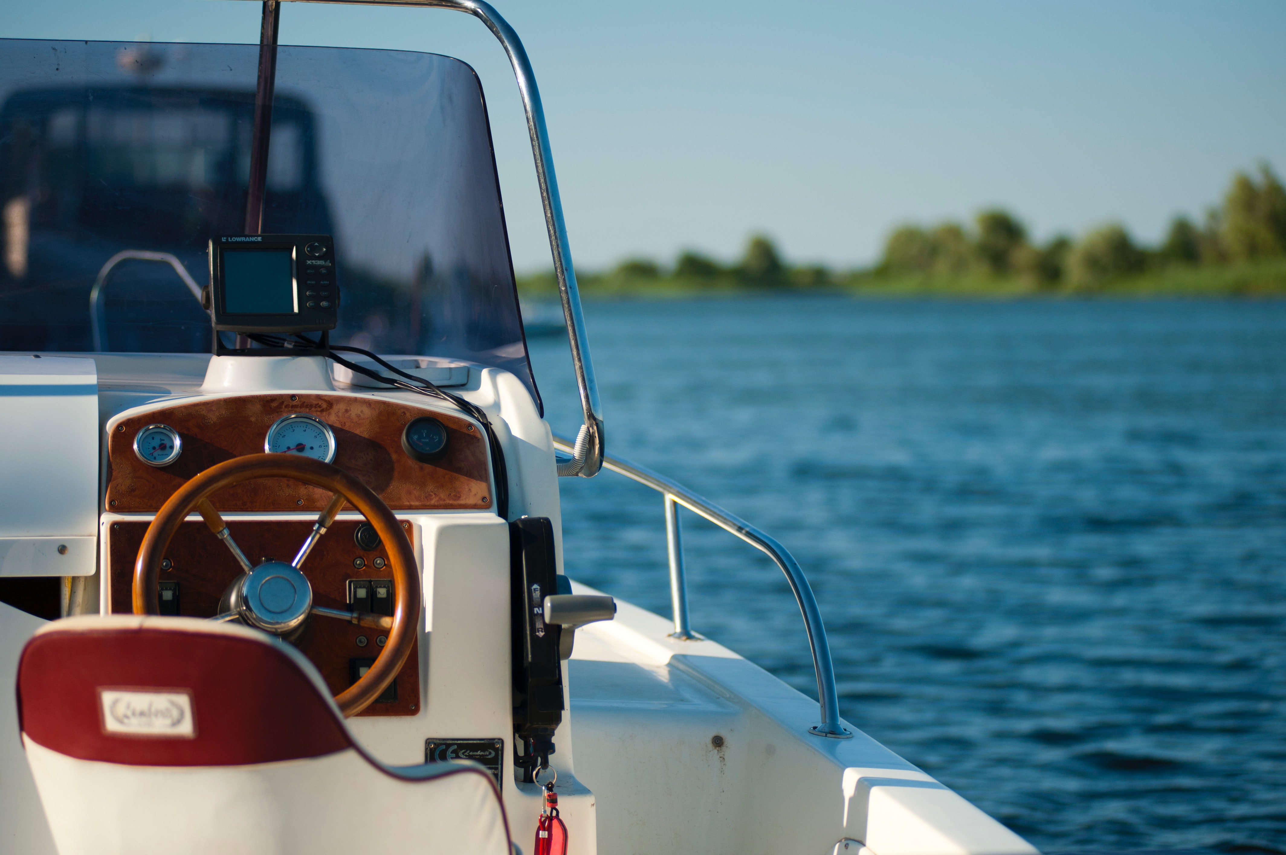 A boat with a steering wheel, ready for summer adventures with Dockshare, ensuring a smooth sailing experience.