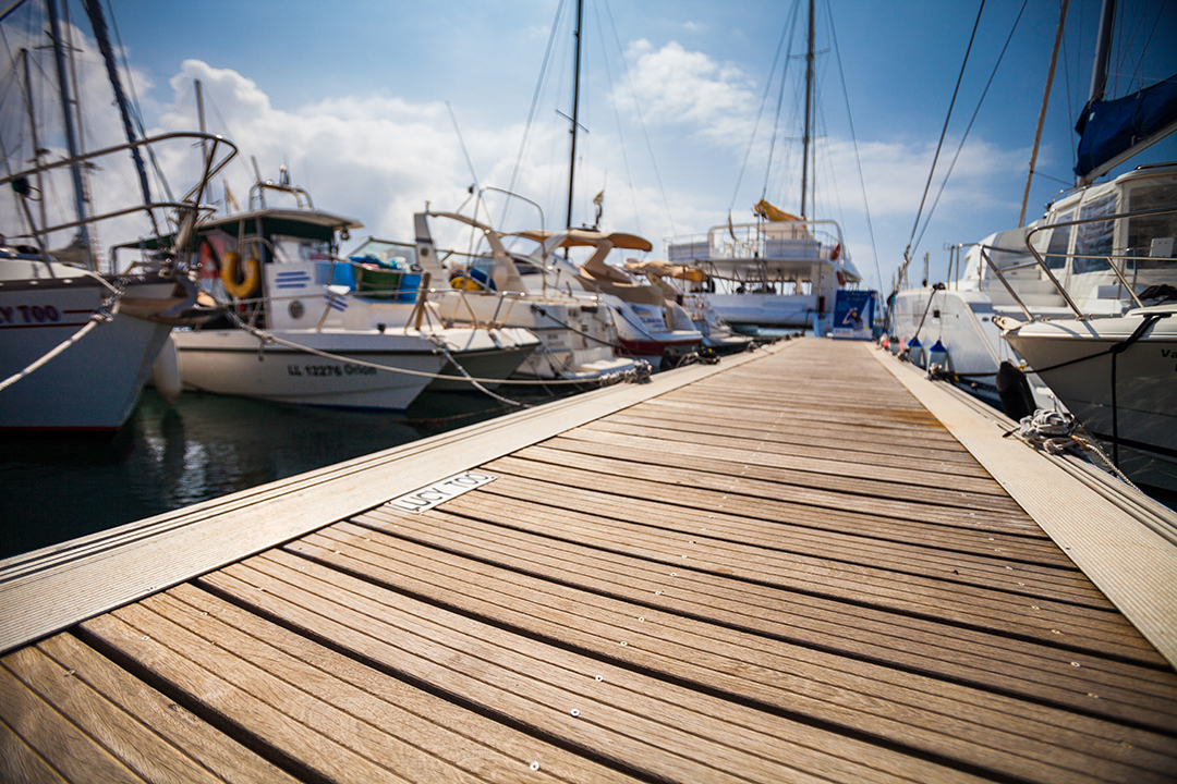 A picturesque wooden walkway extending towards the water, inviting relaxation and enjoyment of waterfront activities. Dockshare.