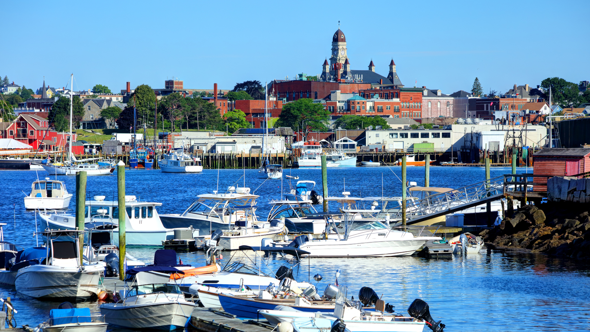 several boats docks and moored in a harbor of private dock rentals near gloucester ma