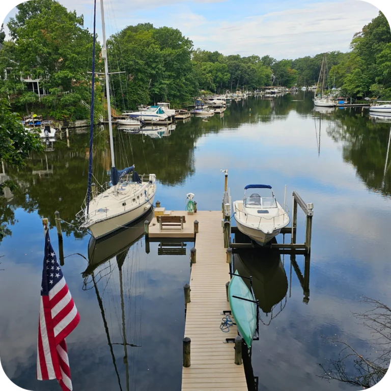 a sailboat is docked next to another small powerboat on a lift