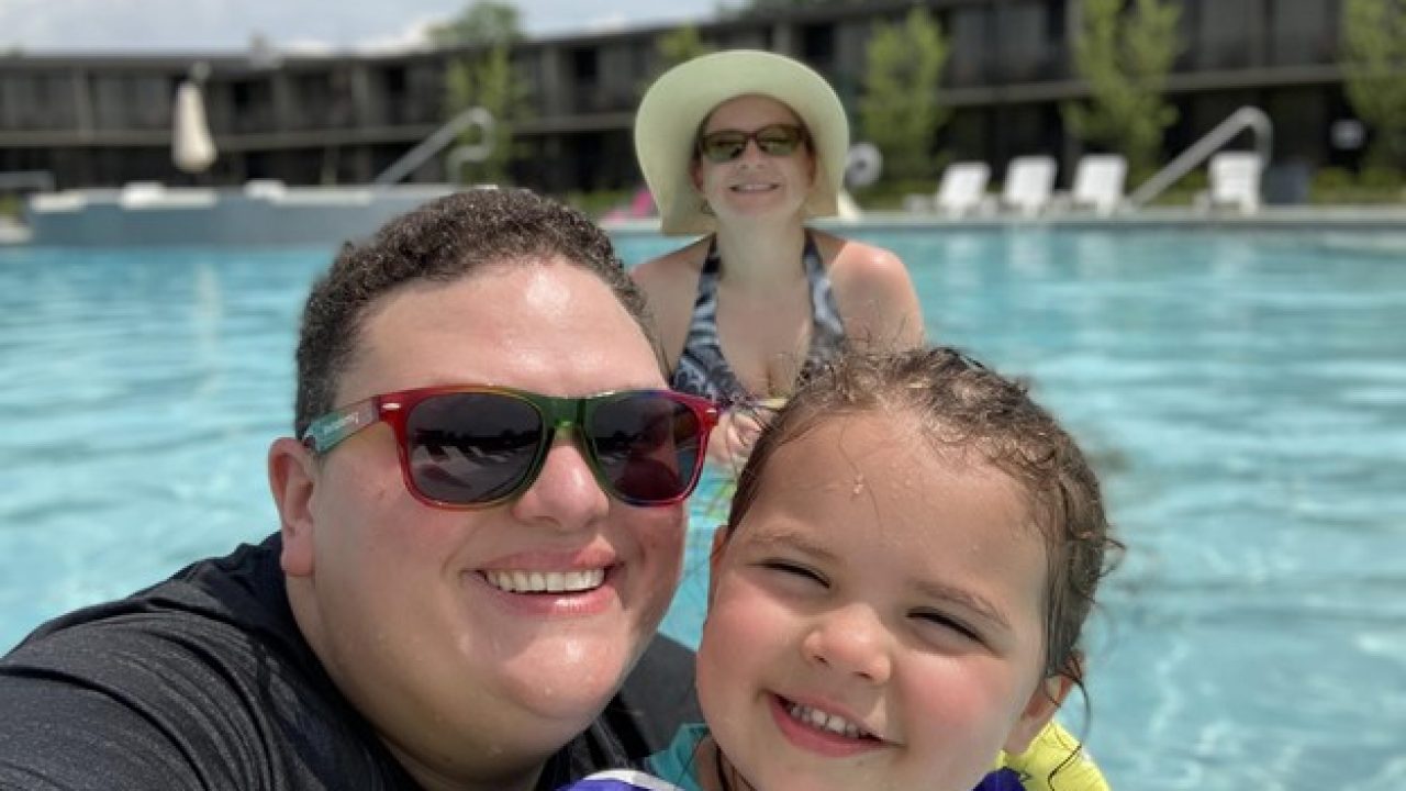 A man and a little girl enjoy a sunny day in the pool, showcasing joy and connection with Dockshare.