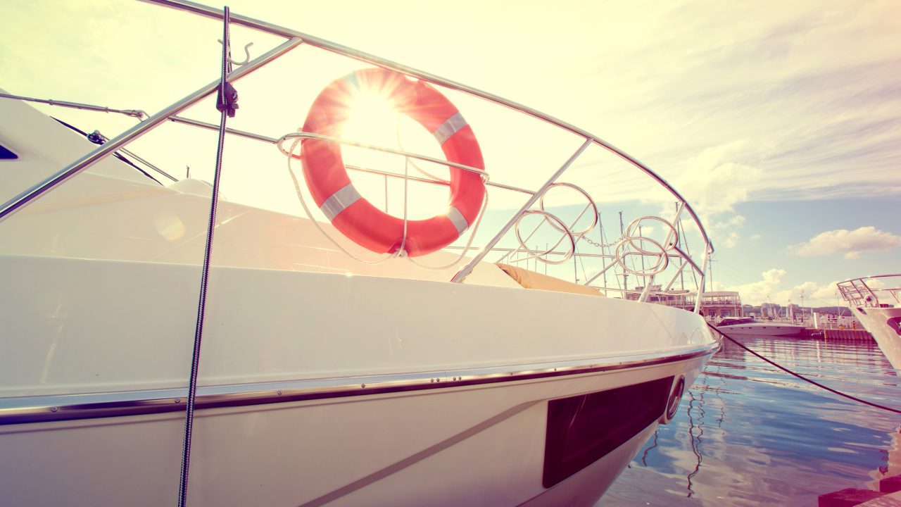 A boat docked at a marina with a life preserver, promoting safety on the water with Dockshare during National Safe Boating Week.